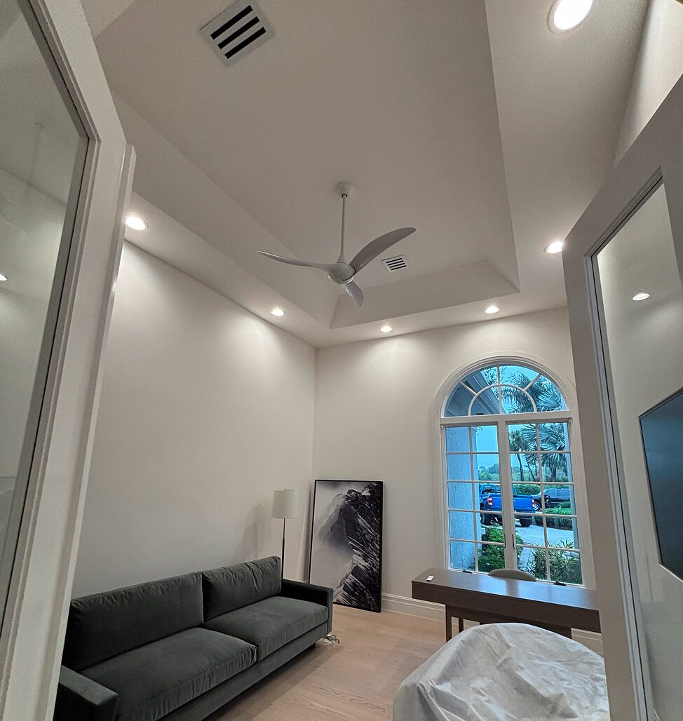 Ceiling fan and recessed lighting in a living room served by Eastern Electric Solutions